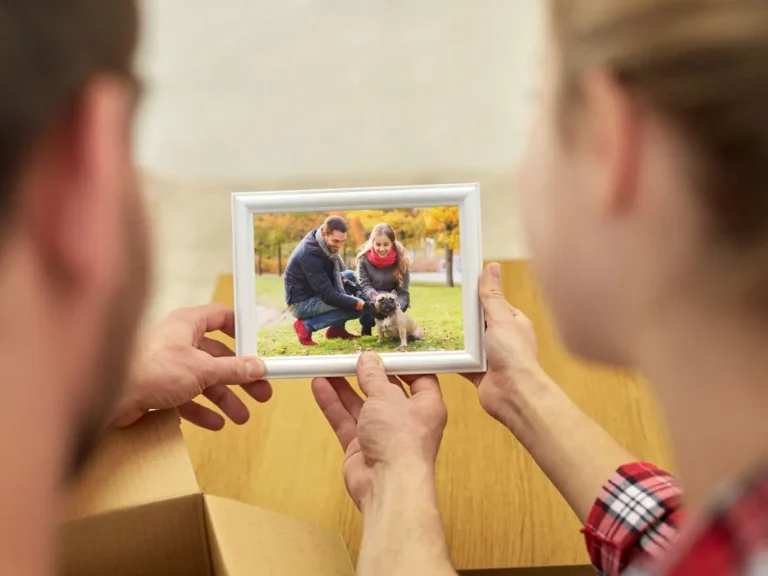 couple looking at a picture of them and their dog