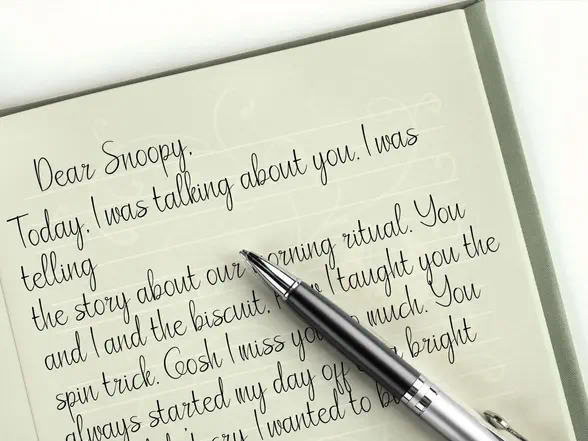 Pet grief journal open with prompt written inside